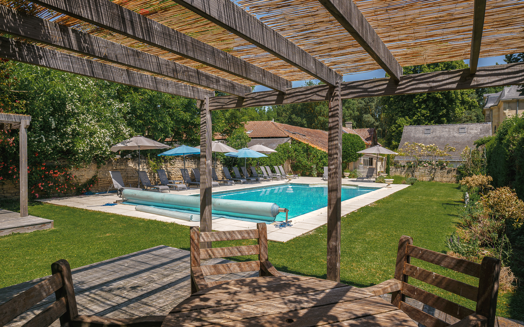 View of swimming pool from pergola at chateau de la vigne
